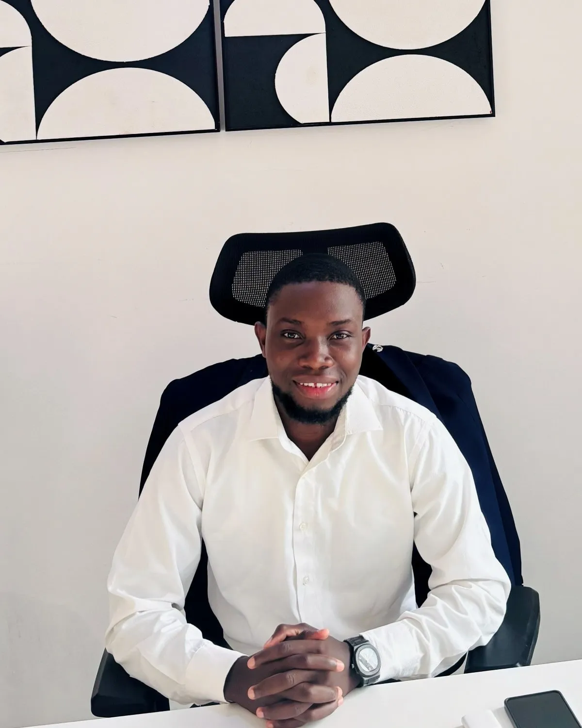 Marick DANSI at his desk in a white shirt